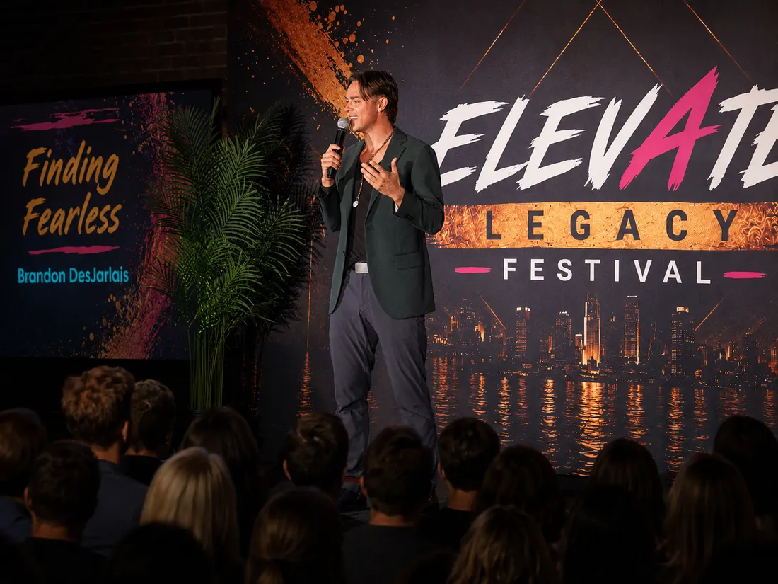 Brandon DesJarlais speaking on stage at the Elevate Legacy Festival